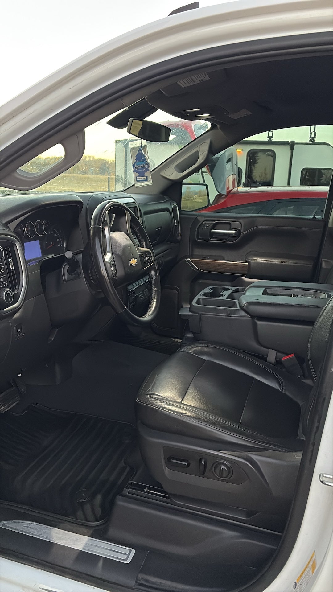 Interior of a vehicle with a focus on the dashboard and steering wheel.