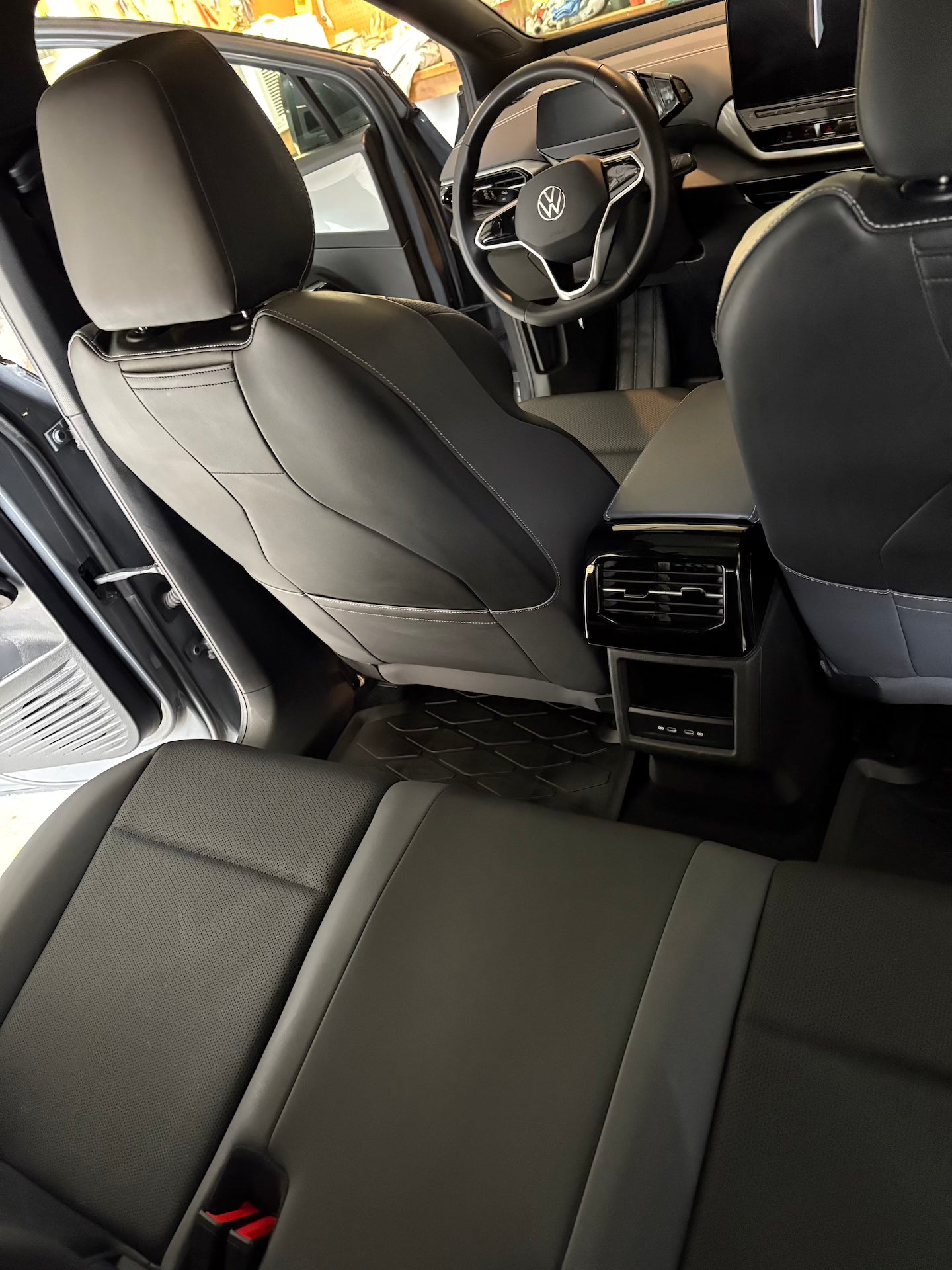 Car interior with gray seats and steering wheel logo