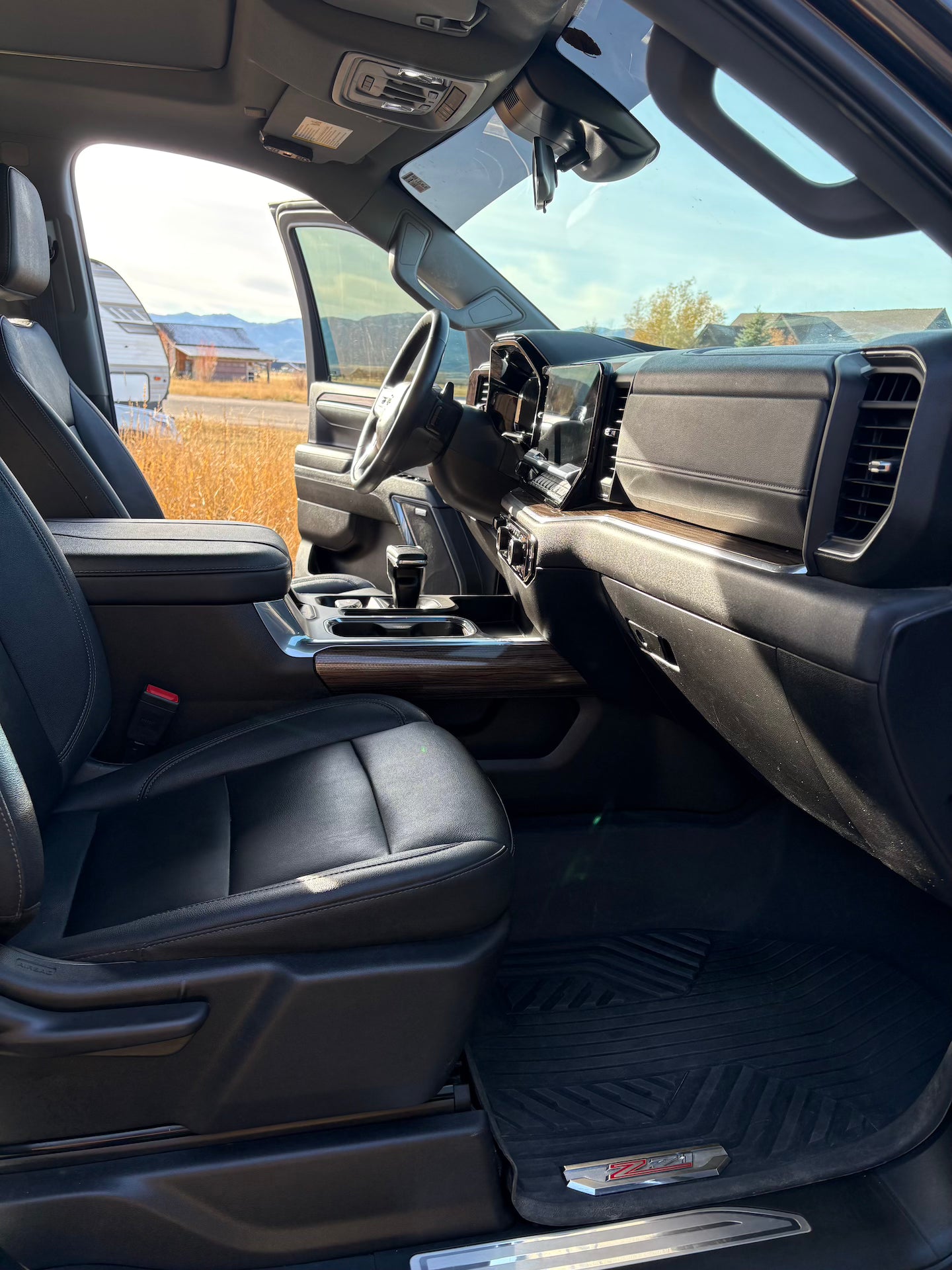 Interior of a vehicle with black leather seats and dashboard.