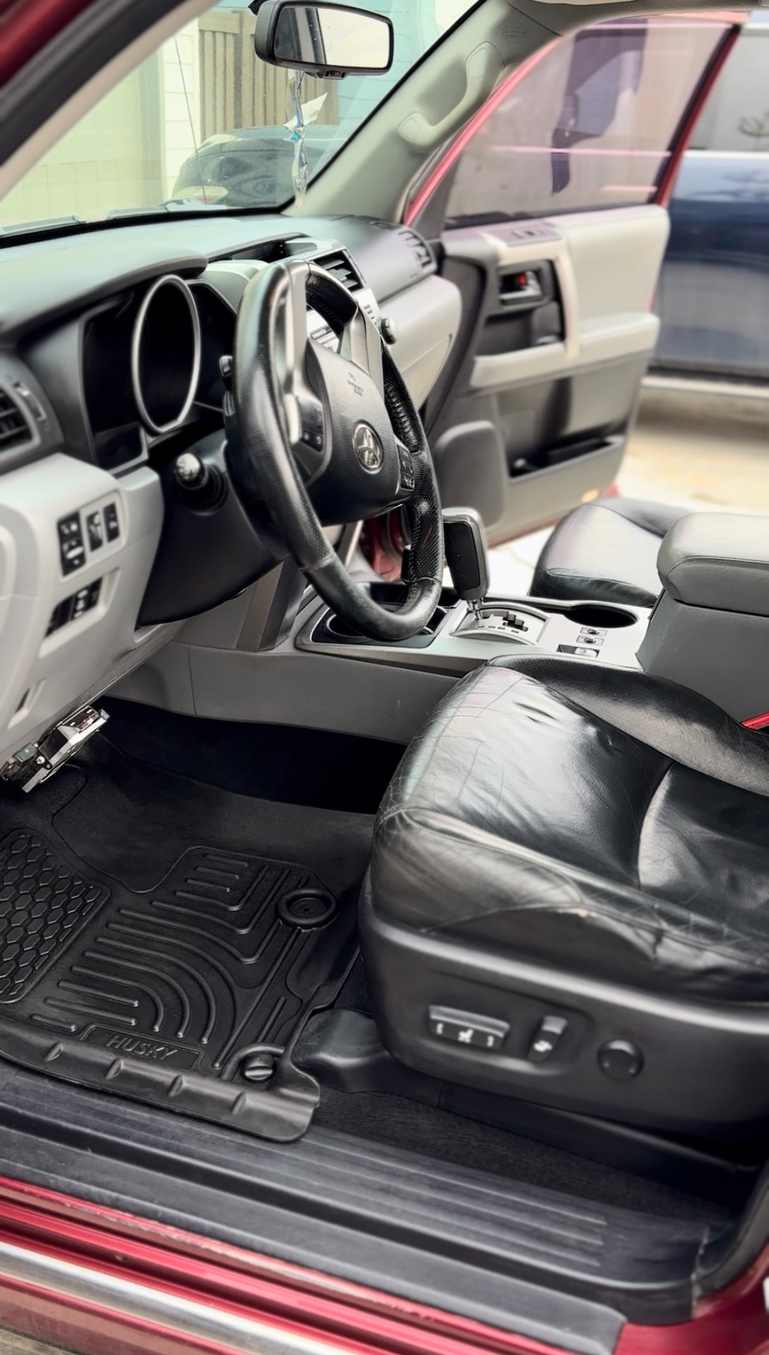 Car interior with a focus on the dashboard, steering wheel, and center console.