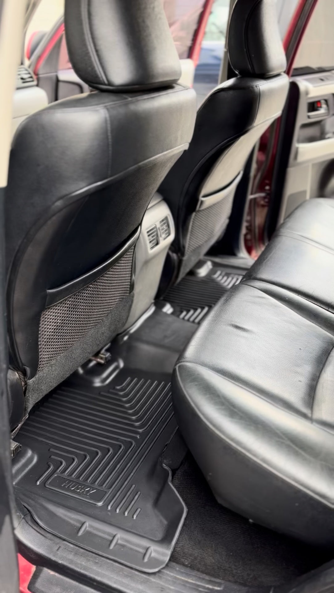 Car interior with black seat covers and floor mats.