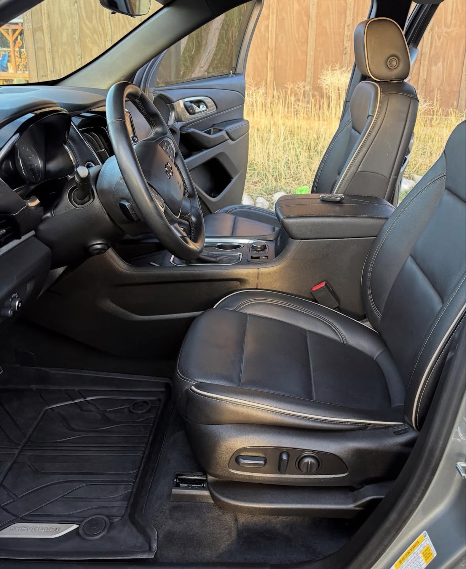 Car interior with steering wheel and dashboard in a natural setting