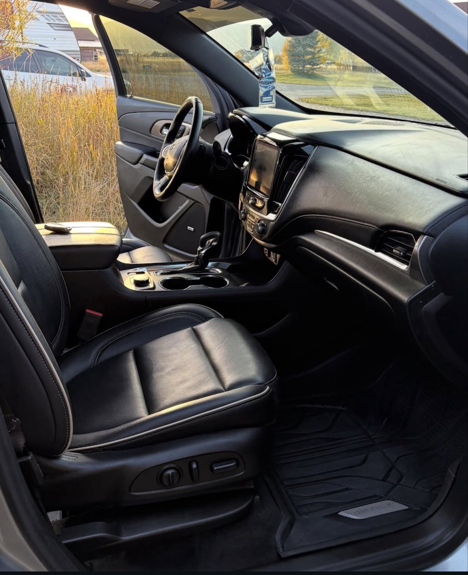 Interior of a car with black leather seats and dashboard.