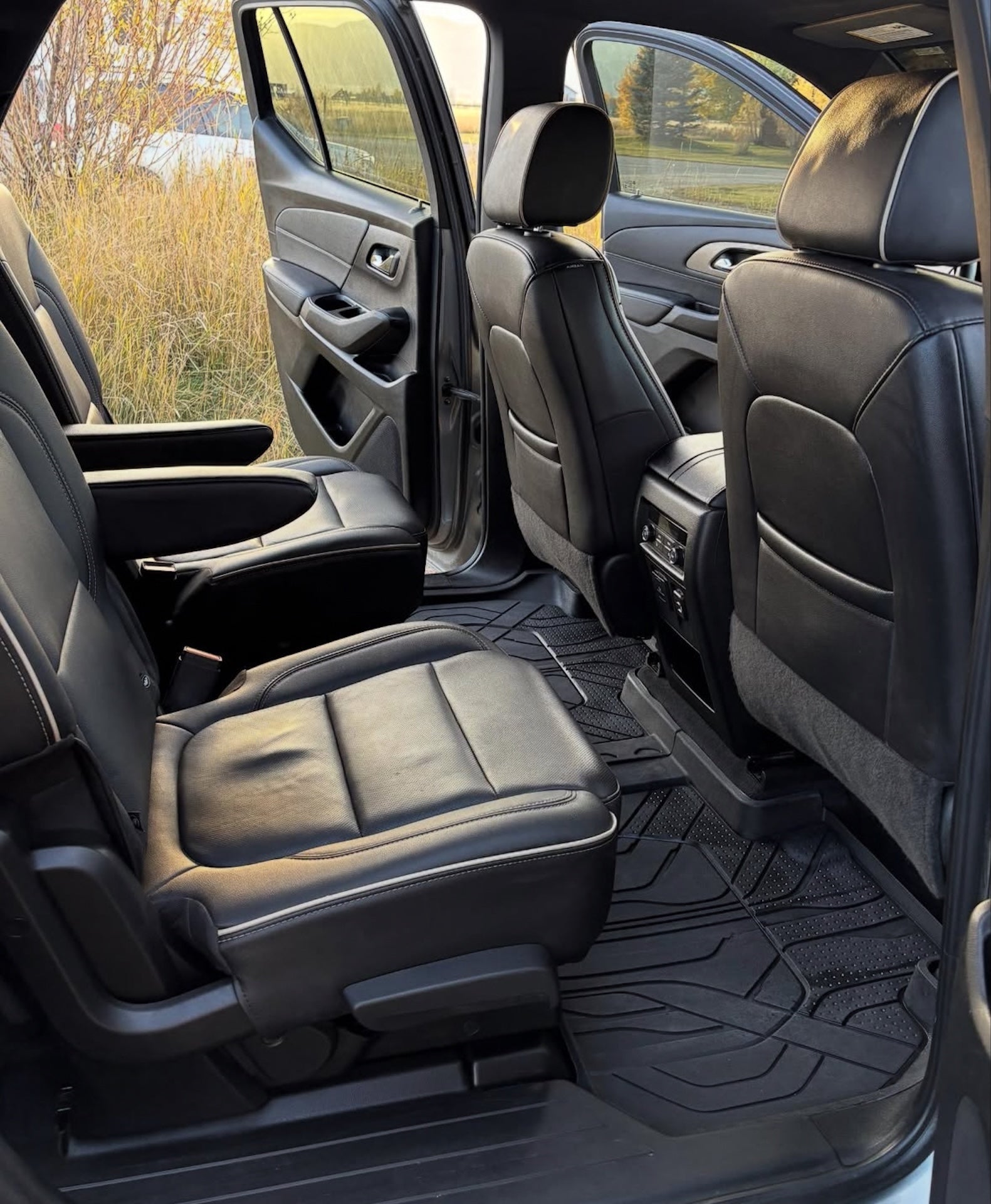 Car interior with black floor mats on a vehicle parked outdoors.