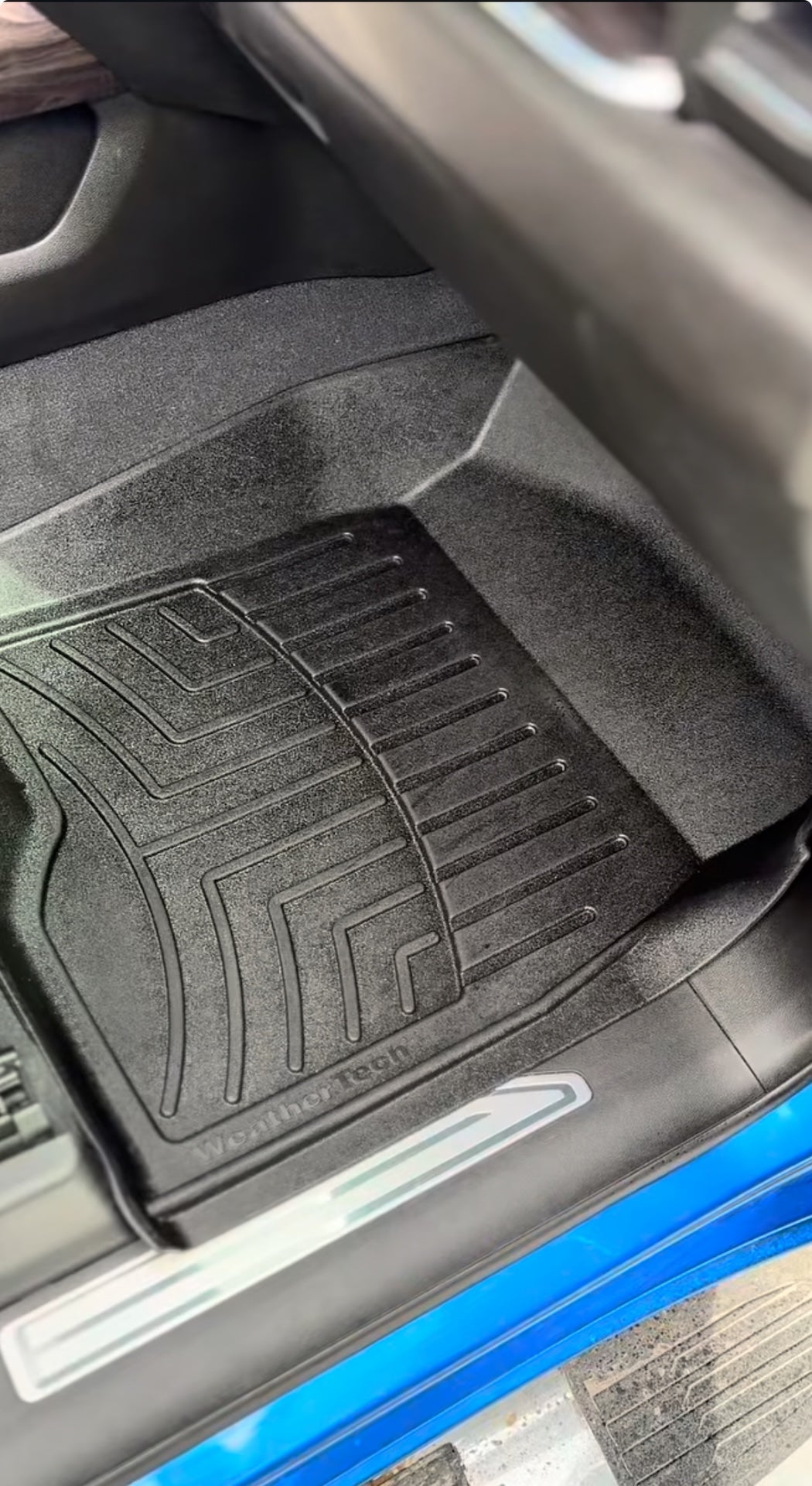 Car interior with black floor mats on a vehicle seat.